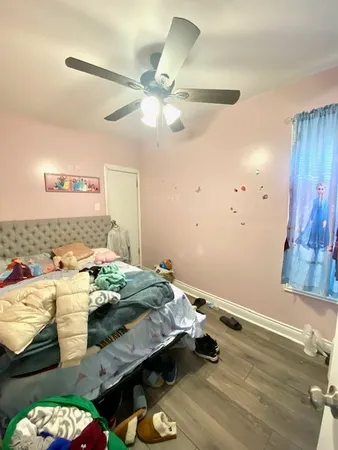 a bedroom with a bed and a ceiling fan