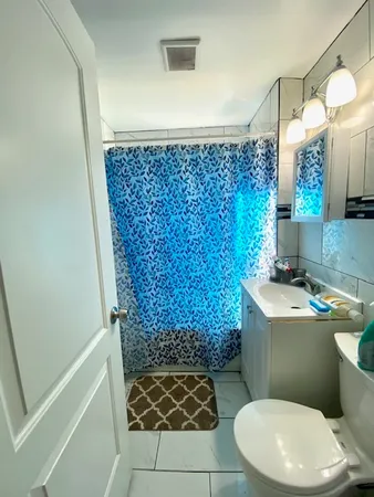 a bedroom with a bed and a chandelier fan