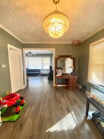 a living room with furniture and a chandelier