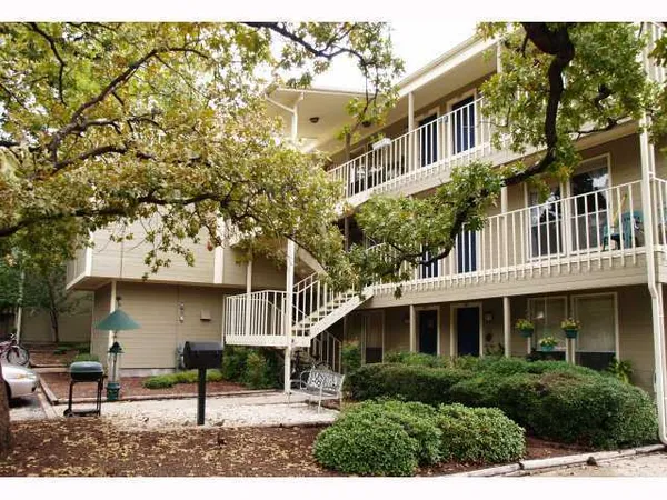 a front view of a building with a garden