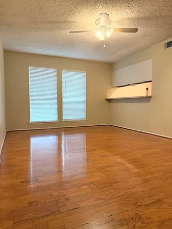 a view of room with window and wooden floor