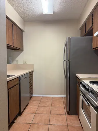 a kitchen with a stove top oven and refrigerator