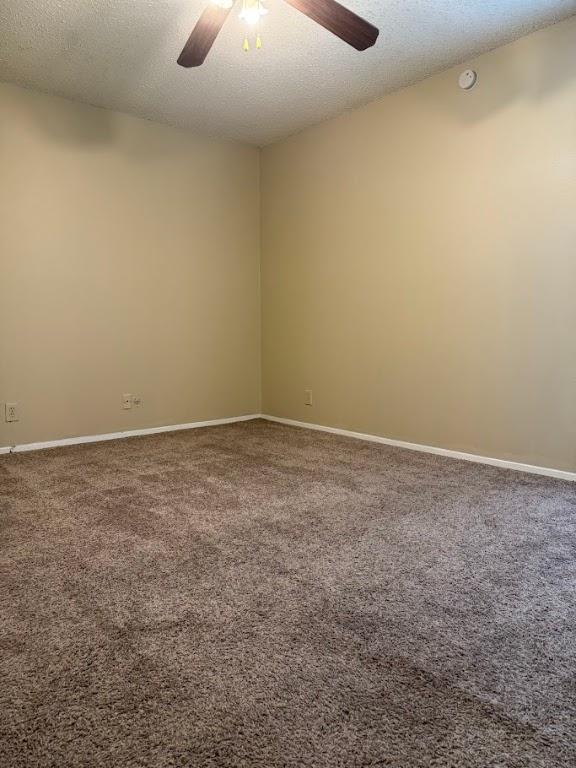 202 East 45th Street, Unit 306 Austin, TX 78751 - Photo 8 of 11 an empty room with a ceiling fan and carpet