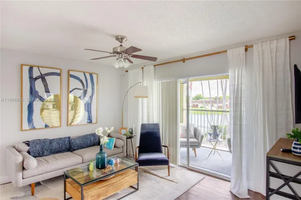 a living room with furniture and a potted plant