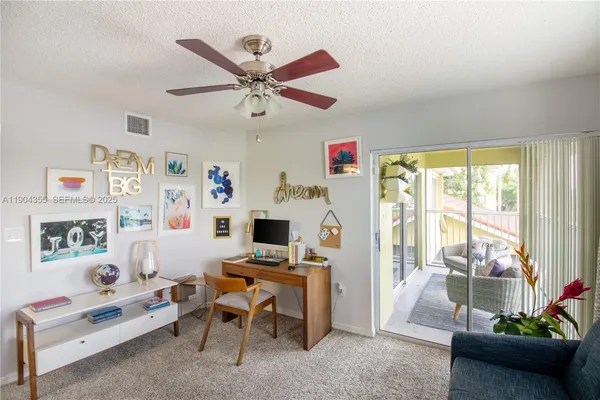 a living room with furniture a flat screen tv and a large window