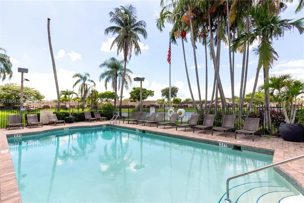 a view of a house with swimming pool and sitting area