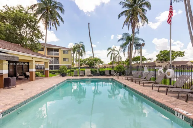 a view of a house with swimming pool and sitting area