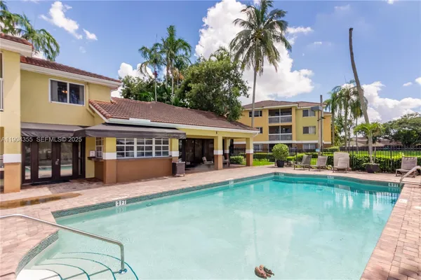 a view of a patio with table and chairs and potted plants