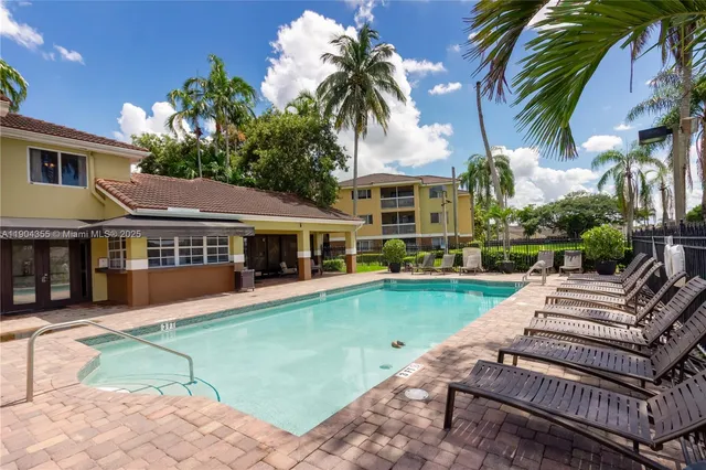 a view of a patio with table and chairs and potted plants