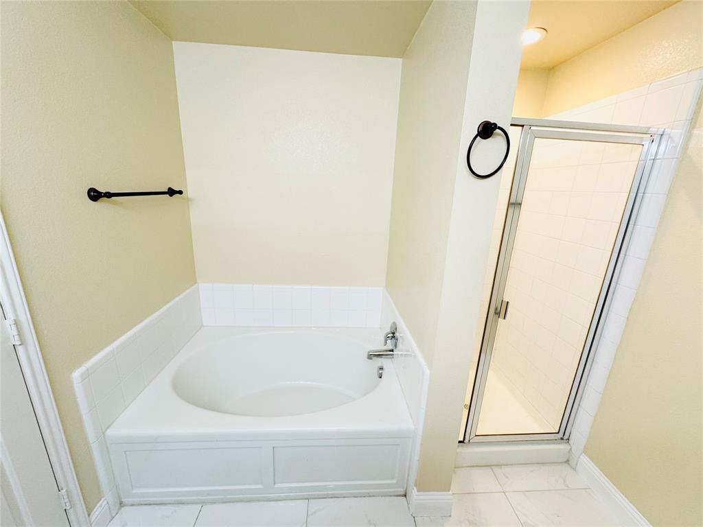 1111 Mount Olive Lane Forney, TX 75126 - Photo 11 of 15 a bathroom with a white bath tub