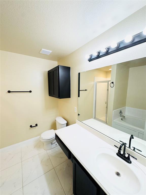 1111 Mount Olive Lane Forney, TX 75126 - Photo 12 of 15 a bathroom with a sink a mirror and a bathtub