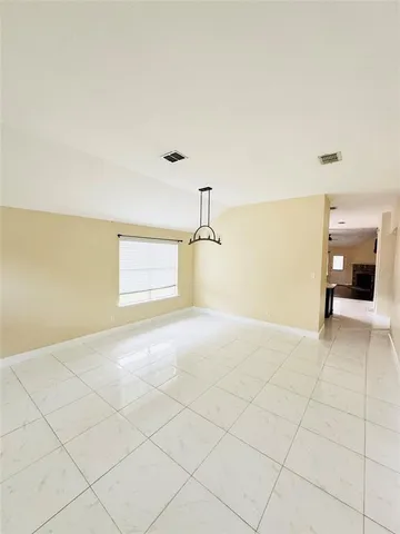 a view of a livingroom with wooden floor and a ceiling fan