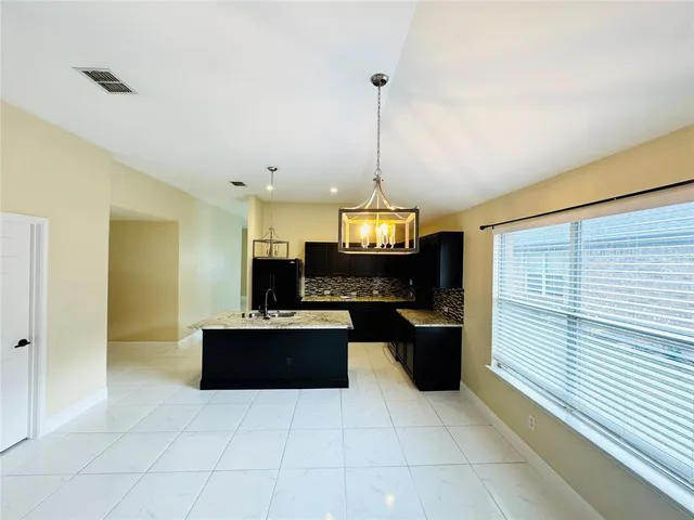 a kitchen with stainless steel appliances granite countertop a sink and cabinets