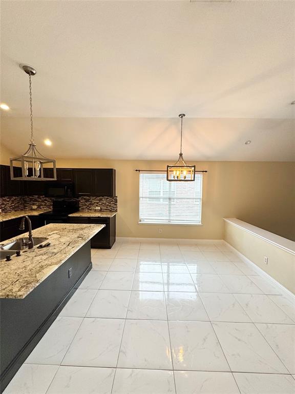 1111 Mount Olive Lane Forney, TX 75126 - Photo 6 of 15 a kitchen with stainless steel appliances granite countertop a sink and cabinets