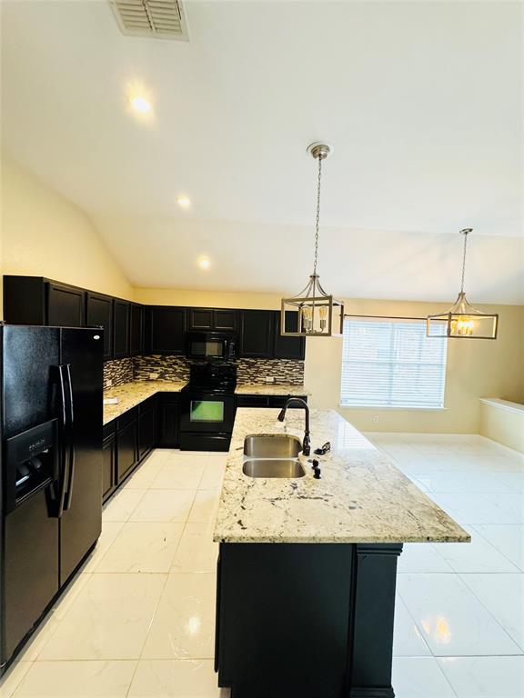 1111 Mount Olive Lane Forney, TX 75126 - Photo 7 of 15 a kitchen with kitchen island sink and stove