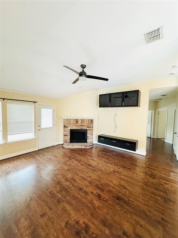 1111 Mount Olive Lane Forney, TX 75126 - Photo 8 of 15 a view of empty room with wooden floor and fireplace