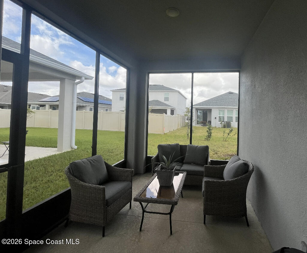 2359 Bonnyton Lane Palm Bay, FL 32907 - Photo 13 of 15 a balcony with furniture and a floor to ceiling window