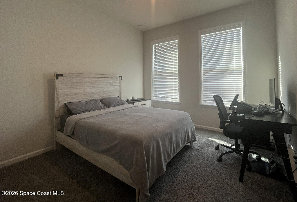 2359 Bonnyton Lane Palm Bay, FL 32907 - Photo 9 of 15 a bedroom with a bed and a desk