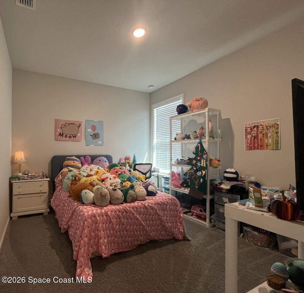 2359 Bonnyton Lane Palm Bay, FL 32907 - Photo 10 of 15 a bedroom with furniture and a chandelier