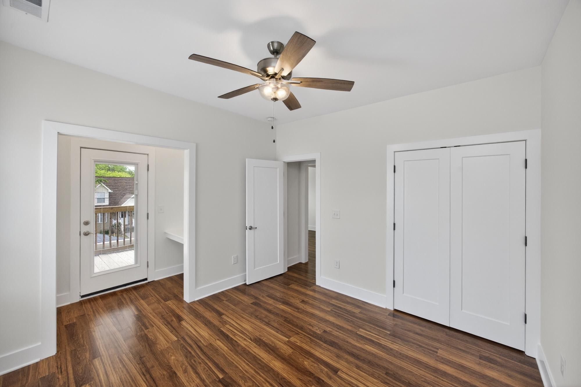 7 Decatur Street Nashville, TN 37210 - Photo 33 of 43 an empty room with wooden floor chandelier fan and windows
