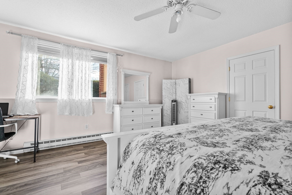 3 Dailey Street, Unit B Attleboro, MA 02703 - Photo 15 of 30 a spacious bedroom with a large bed and a chandelier