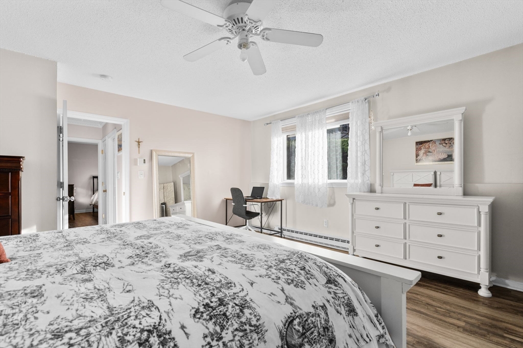 3 Dailey Street, Unit B Attleboro, MA 02703 - Photo 16 of 30 a bedroom with a bed and a chandelier
