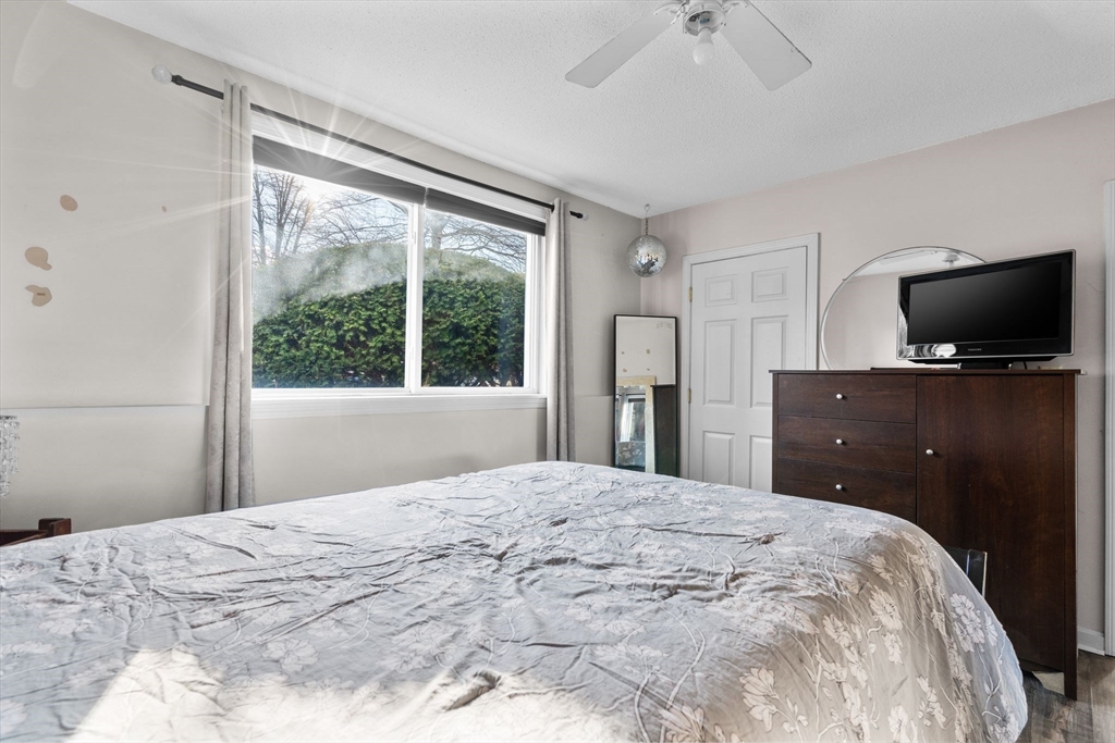 3 Dailey Street, Unit B Attleboro, MA 02703 - Photo 19 of 30 a bedroom with a large bed and a flat screen tv