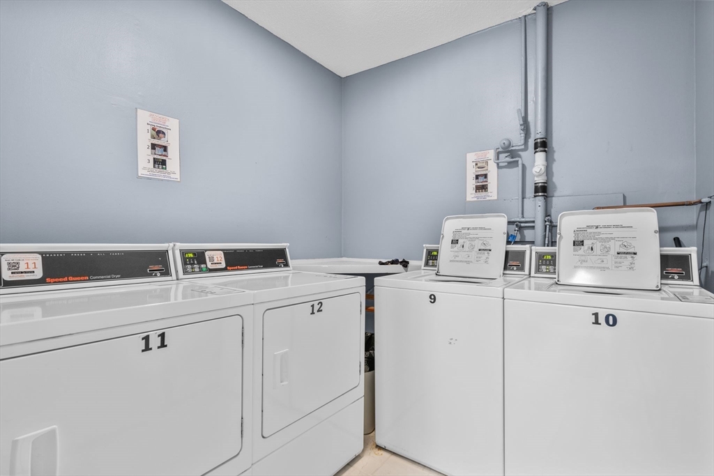 3 Dailey Street, Unit B Attleboro, MA 02703 - Photo 21 of 30 a room with cabinets a washer and dryer
