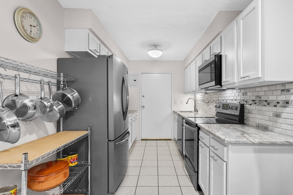 3 Dailey Street, Unit B Attleboro, MA 02703 - Photo 8 of 30 a kitchen with stainless steel appliances granite countertop a refrigerator a stove a sink and a microwave