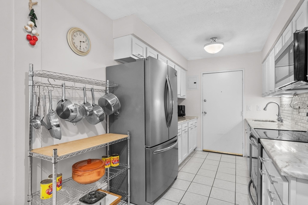 3 Dailey Street, Unit B Attleboro, MA 02703 - Photo 9 of 30 a kitchen with stainless steel appliances a refrigerator and a stove