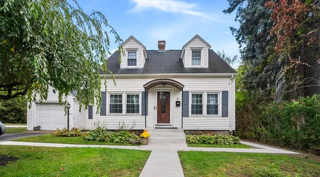 a front view of a house with a garden