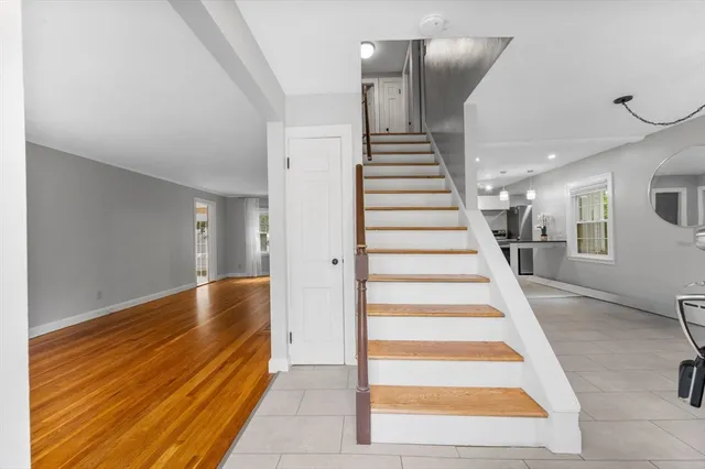 a view of entryway and hall with wooden floor