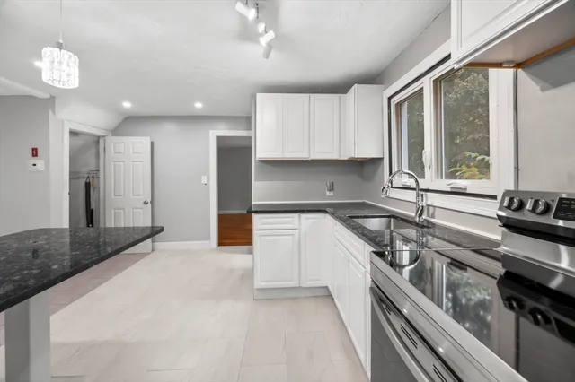 a kitchen with a stove a sink and a refrigerator