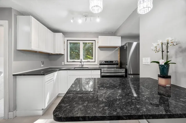 a kitchen with sink refrigerator and window