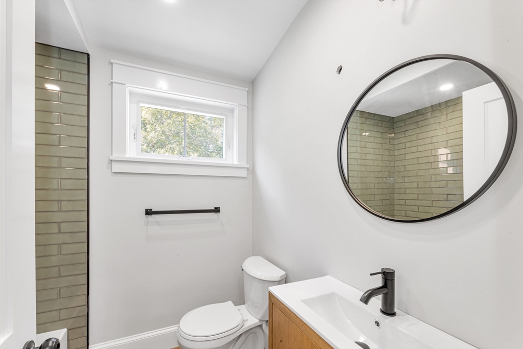 180 Dent Street Boston, MA 02132 - Photo 15 of 30 a bathroom with a sink mirror and toilet