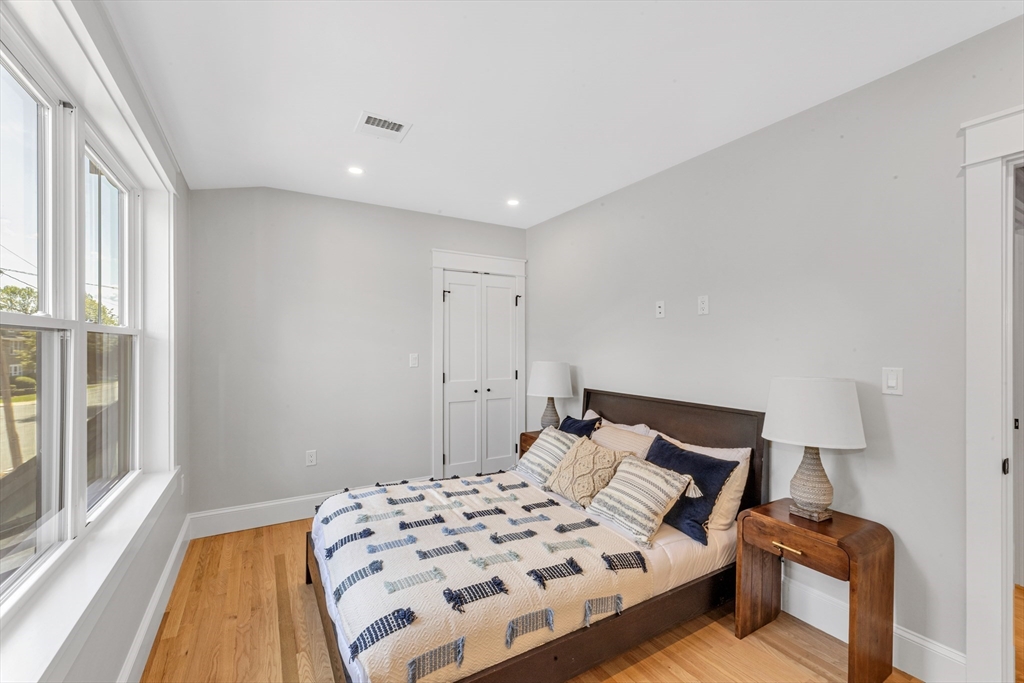 180 Dent Street Boston, MA 02132 - Photo 19 of 30 a bedroom with a bed and a large window