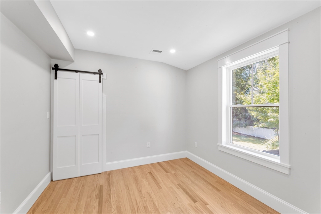 180 Dent Street Boston, MA 02132 - Photo 20 of 30 a view of empty room with wooden floor and fan
