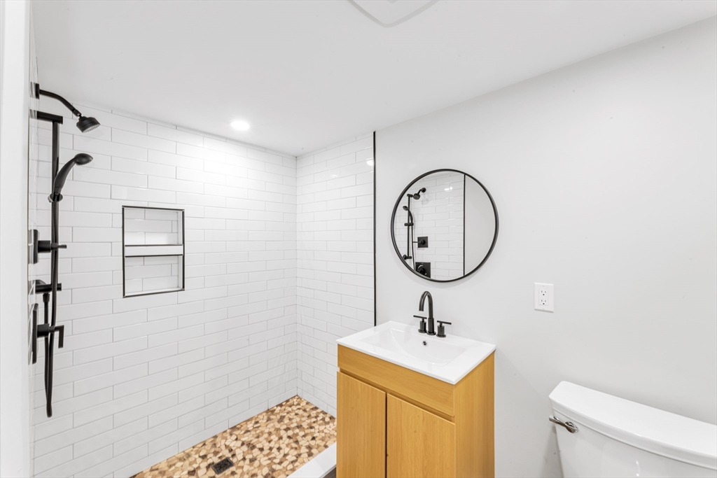 180 Dent Street Boston, MA 02132 - Photo 22 of 30 a bathroom with a toilet a sink and a mirror