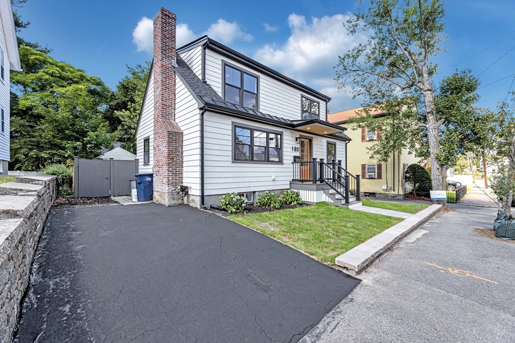 180 Dent Street Boston, MA 02132 - Photo 26 of 30 a front view of a house with a yard and potted plants