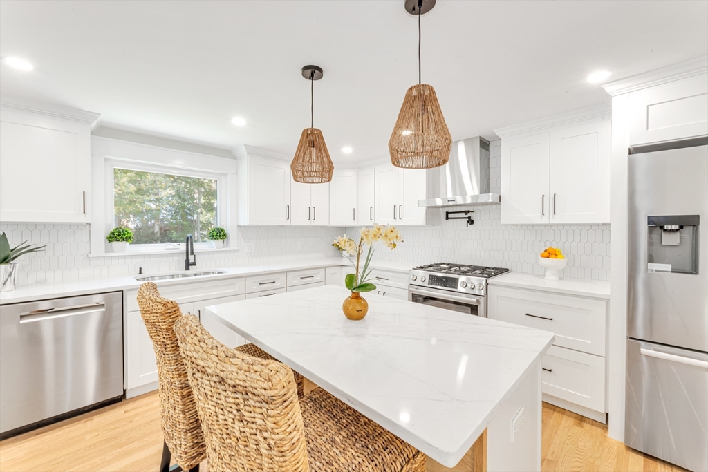 180 Dent Street Boston, MA 02132 - Photo 9 of 30 a kitchen with a refrigerator a stove a sink and a window
