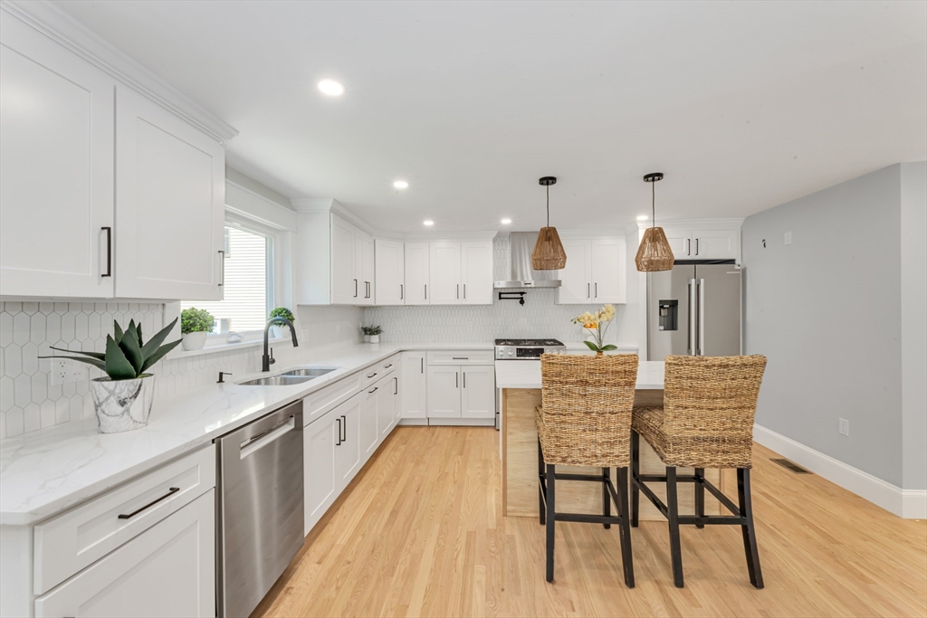 180 Dent Street Boston, MA 02132 - Photo 10 of 30 a kitchen with stainless steel appliances granite countertop a white cabinets and wooden floor