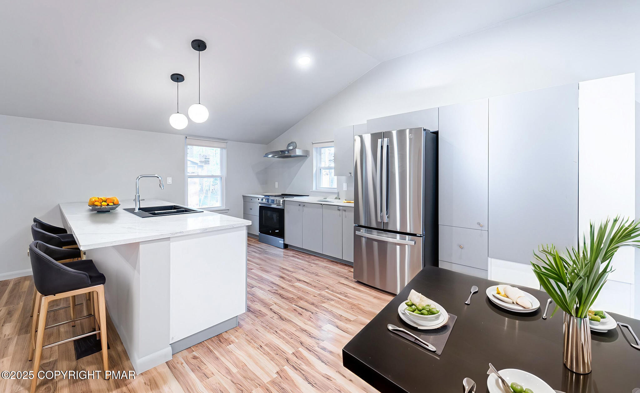 113 Netcong Circle Pocono Lake, PA 18347 - Photo 17 of 51 a kitchen with sink refrigerator dining table and chairs