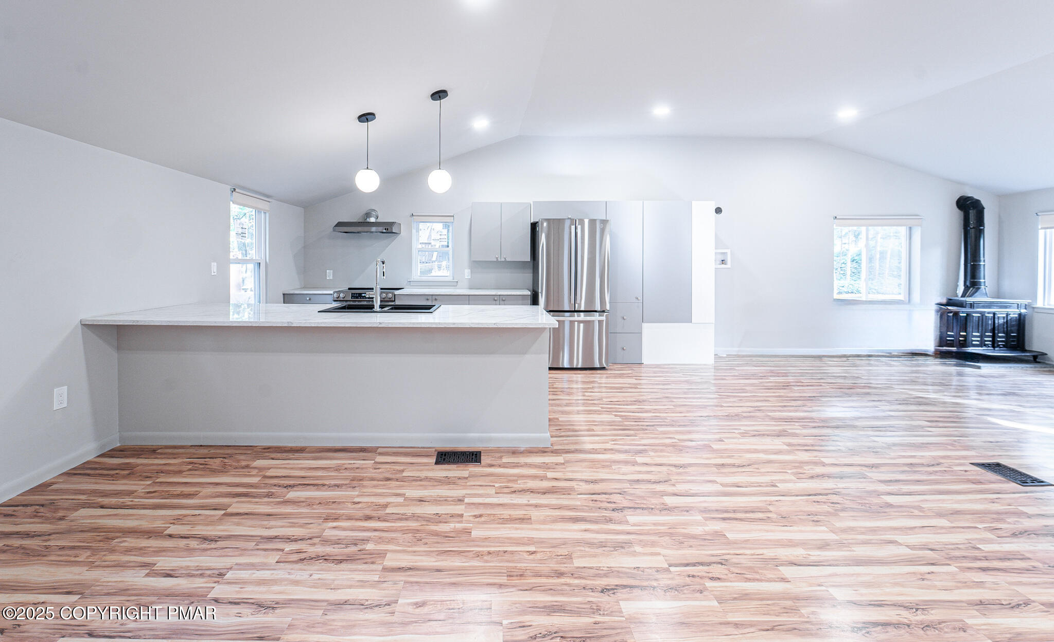 113 Netcong Circle Pocono Lake, PA 18347 - Photo 24 of 51 a view of a kitchen with kitchen island a sink wooden floor and a refrigerator