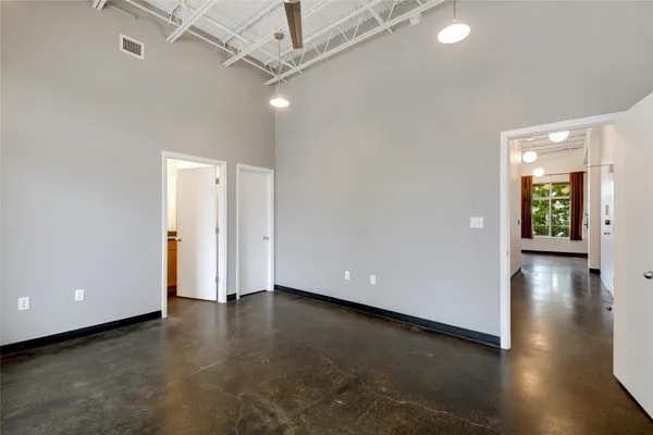 a view of an empty room and a window