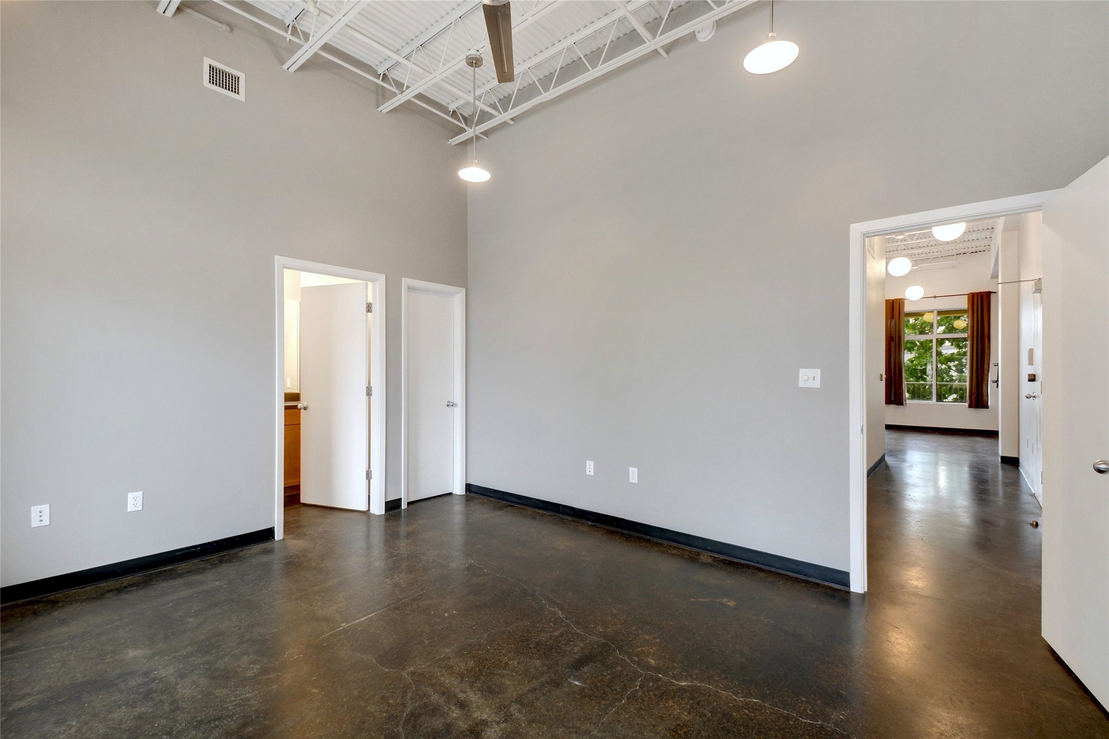 2401 East 6th Street, Unit 41 Austin, TX 78702 - Photo 13 of 23 an empty room with wooden floor and windows
