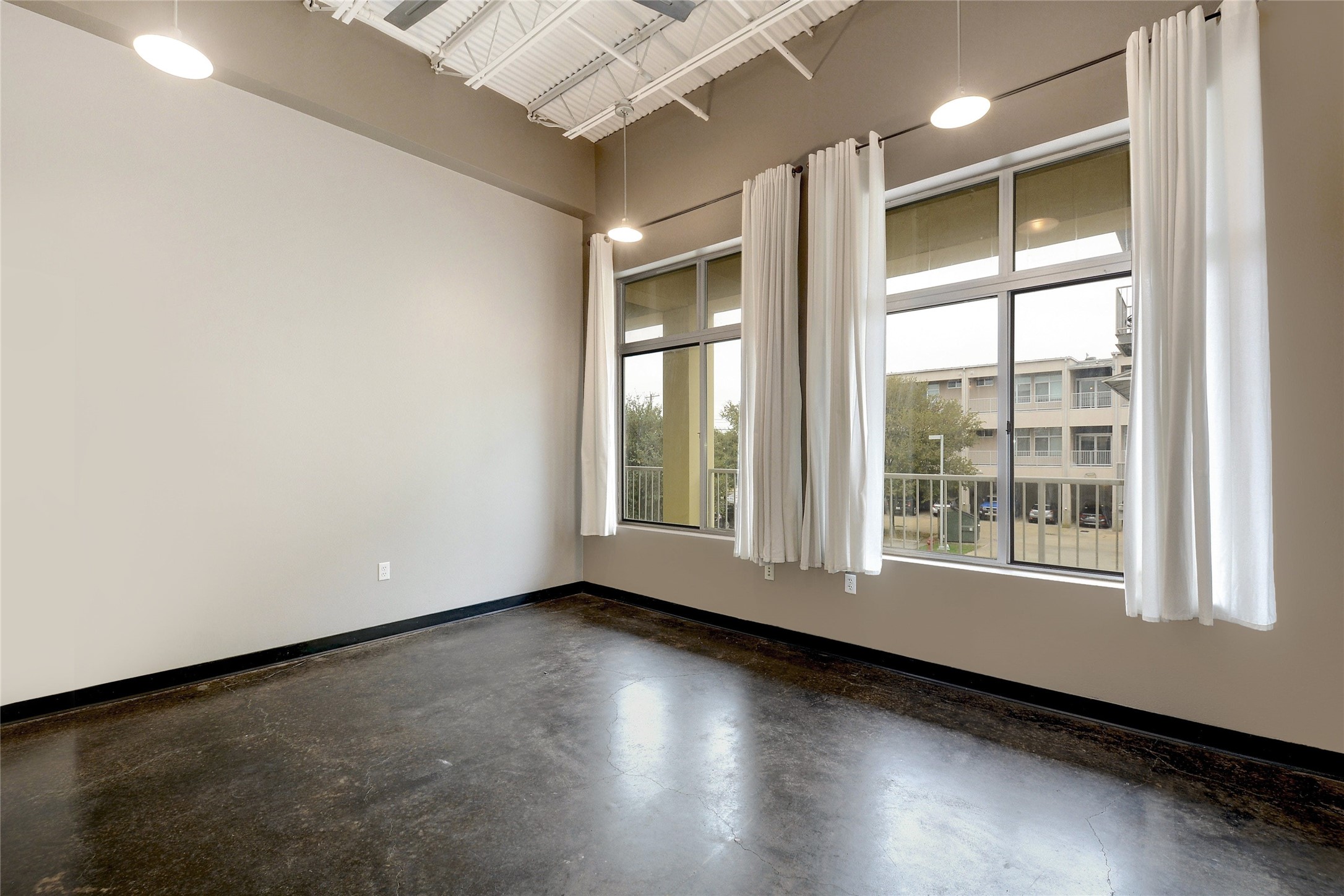 2401 East 6th Street, Unit 41 Austin, TX 78702 - Photo 14 of 23 an empty room with wooden floor and windows