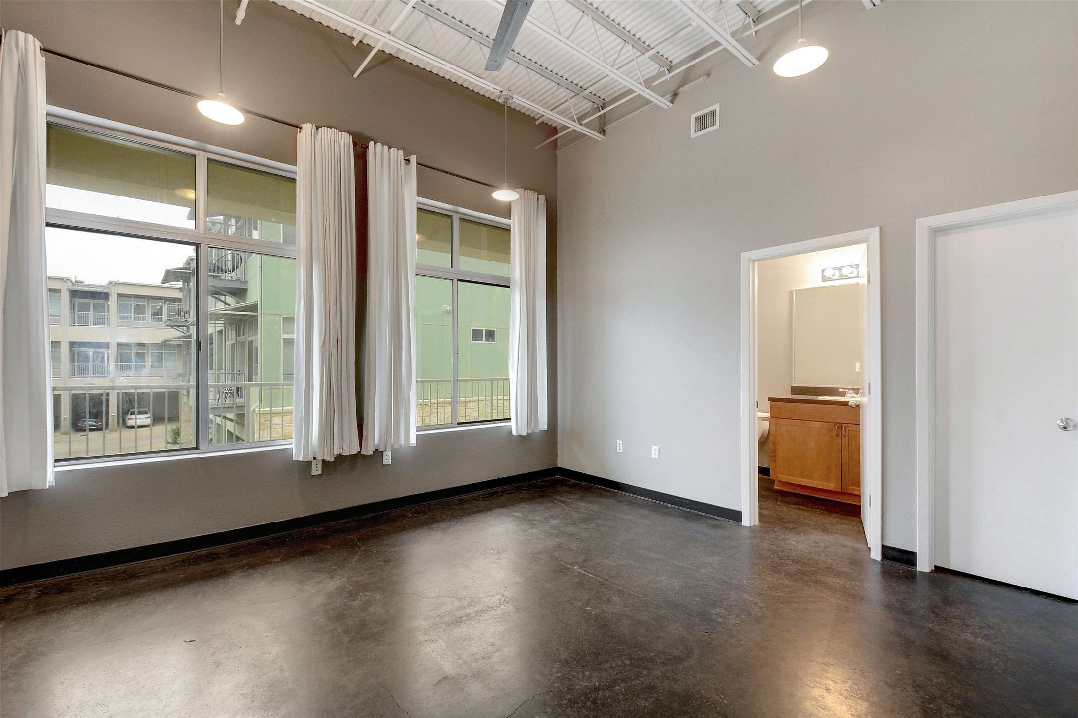 2401 East 6th Street, Unit 41 Austin, TX 78702 - Photo 15 of 23 an empty room with wooden floor and windows