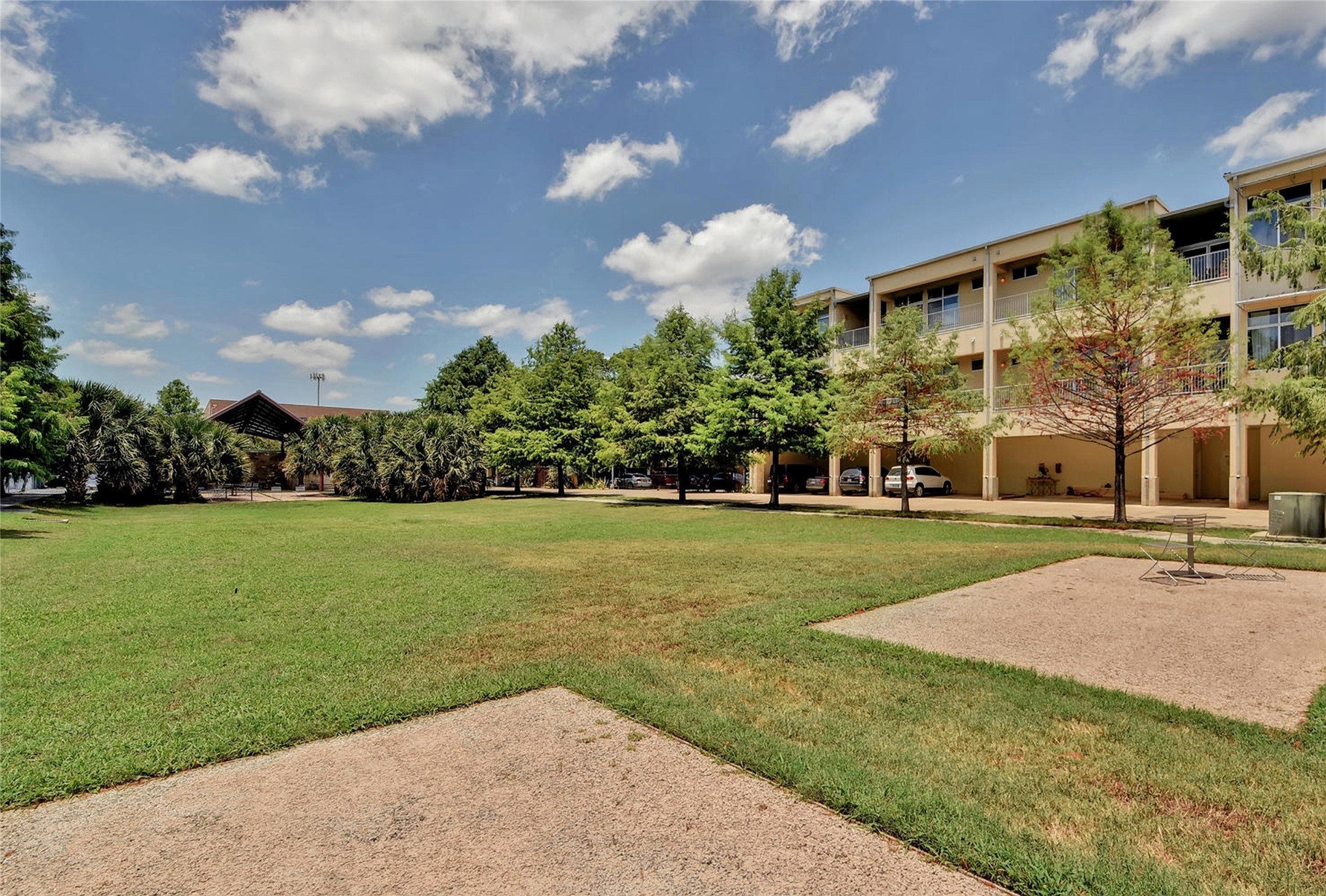 2401 East 6th Street, Unit 41 Austin, TX 78702 - Photo 21 of 23 a view of a fountain in front of a house with a big yard