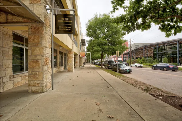 a view of a fountain in front of a house with a big yard