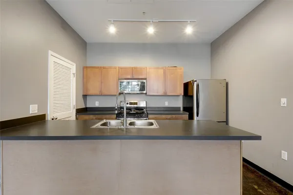 a kitchen with stainless steel appliances granite countertop a sink stove and microwave
